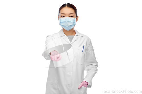 Image of asian female doctor in mask pointing finger to you