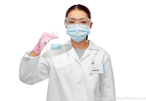 Image of asian female scientist in mask with chemical