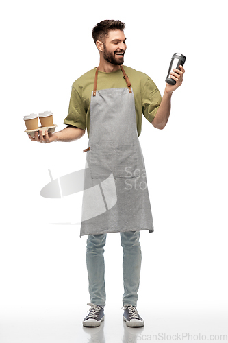 Image of happy waiter with takeout coffee cups and tumbler