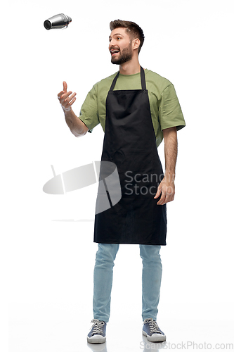 Image of happy barman in apron with shaker preparing drink