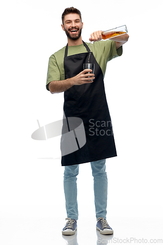 Image of barman with bottle and shaker preparing drink