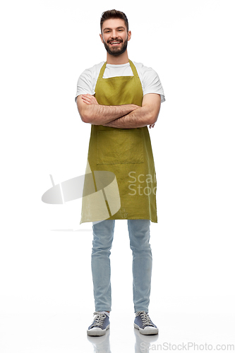 Image of happy barman or waiter in apron with crossed arms