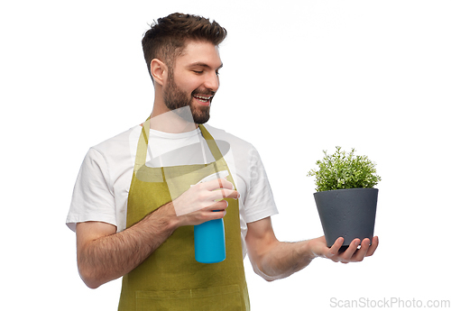 Image of happy smiling male gardener moisturizing flower