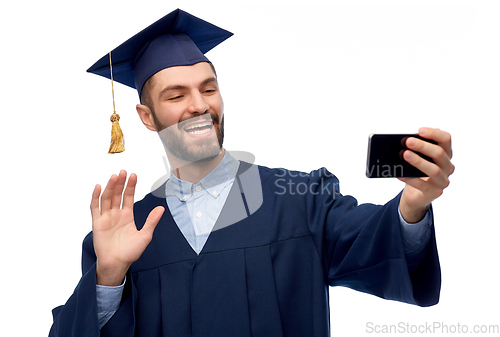 Image of male graduate student with smartphone takes selfie