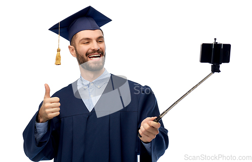 Image of male graduate student with smartphone takes selfie