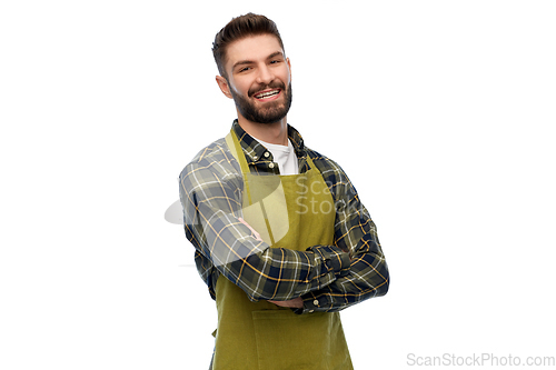 Image of happy young male gardener or farmer in apron