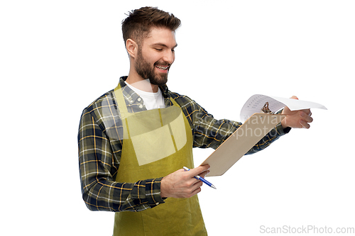 Image of happy male gardener with clipboard