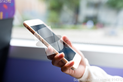 Image of Woman use of mobile phone inside bus of Hong Kong