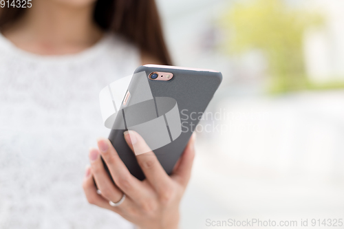 Image of Woman browsing internet on smart phone