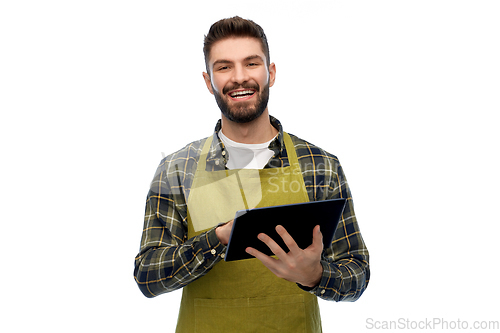 Image of happy male gardener or farmer with tablet pc