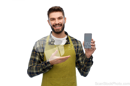 Image of happy male gardener or farmer with smartphone