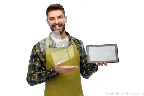 Image of happy male gardener or farmer with tablet pc