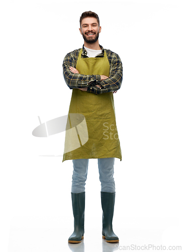 Image of happy young male gardener or farmer in apron