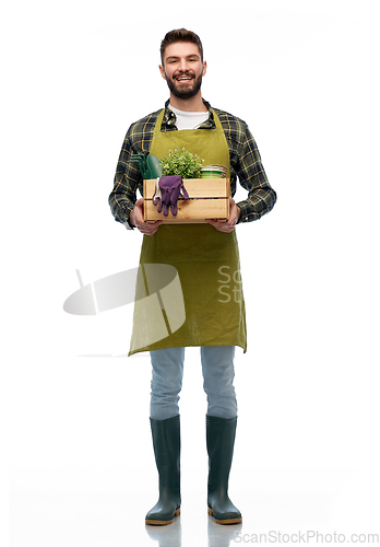 Image of happy gardener or farmer with box of garden tools