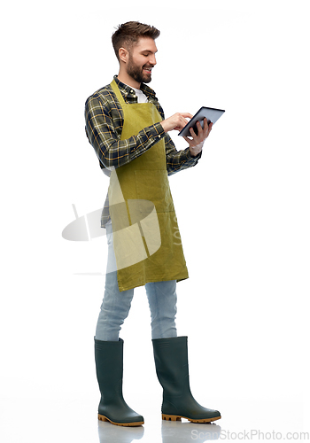 Image of happy male gardener or farmer with tablet pc