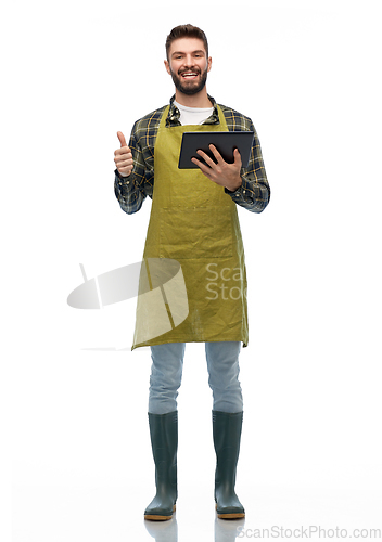 Image of happy male gardener or farmer with tablet pc