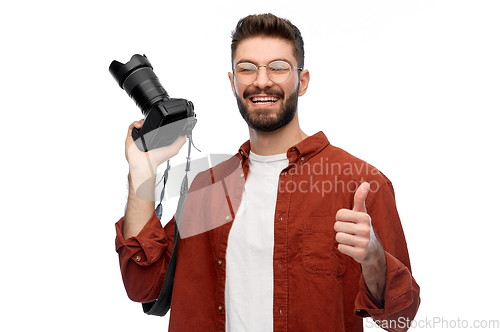 Image of man or photographer with camera showing thumbs up