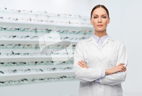 Image of female doctor in white coat at optical store