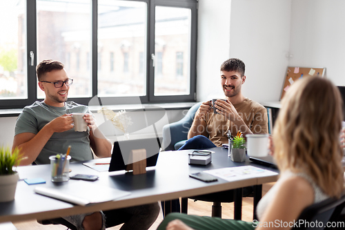 Image of team of startuppers drinking coffee at office