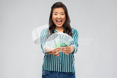 Image of asian woman with hundred euro money banknotes