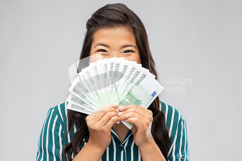 Image of asian woman with hundred euro money banknotes