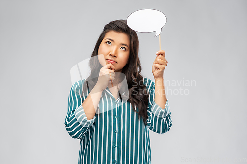 Image of thinking asian woman holding speech bubble