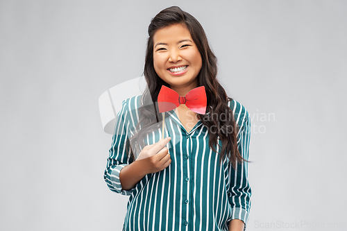 Image of happy asian woman with red party bow