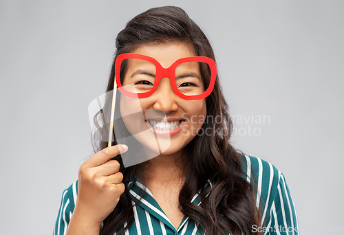 Image of happy asian woman with big party glasses