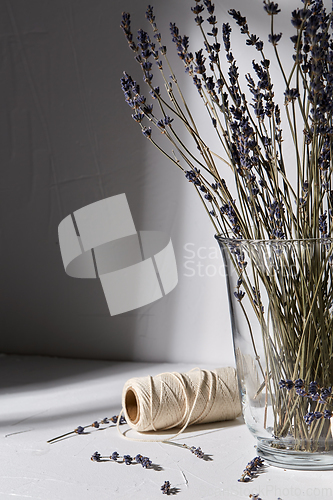 Image of dried lavender flowers in vase and craft rope