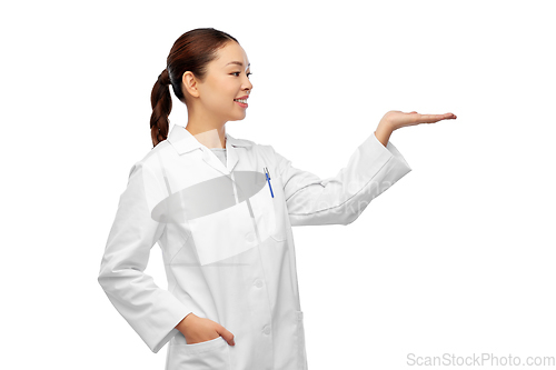 Image of asian female doctor holding something on hand