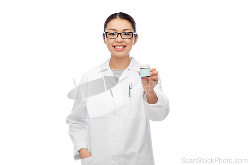 Image of smiling asian female doctor or nurse with medicine