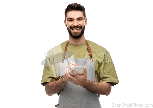 Image of smiling waiter in apron taking notes to notepad