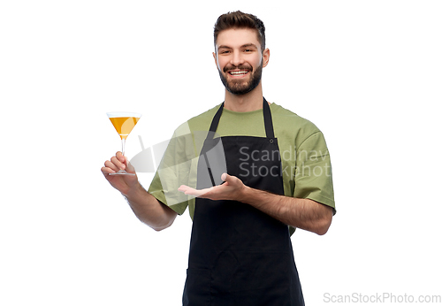 Image of happy barman in apron with glass of cocktail