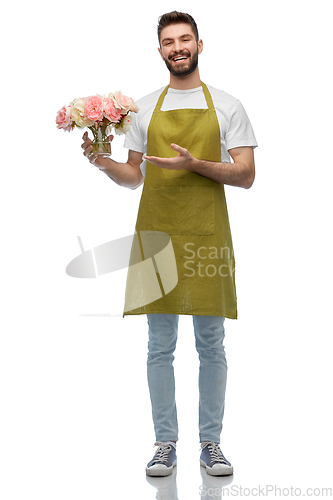 Image of happy smiling male gardener with flowers in vase