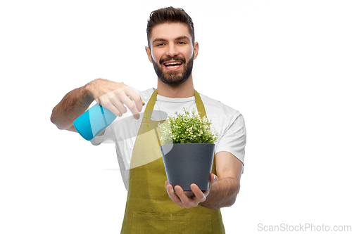 Image of happy smiling male gardener moisturizing flower