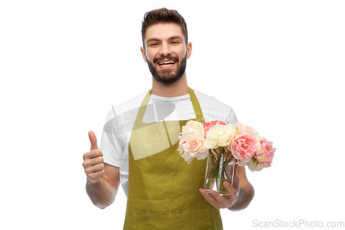 Image of happy male gardener with flowers showing thumbs up