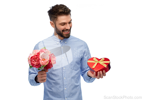 Image of happy man with flowers and valentine's day gift