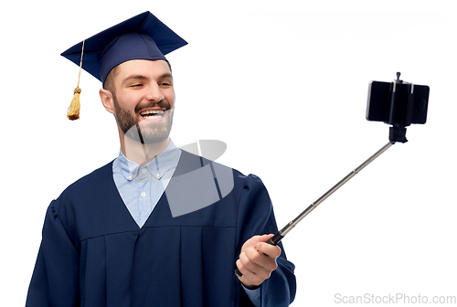 Image of male graduate student with smartphone takes selfie