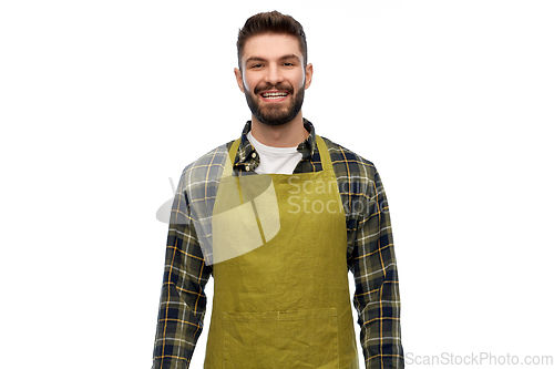 Image of happy young male gardener or farmer in apron