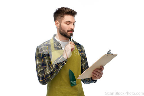Image of male gardener with clipboard and pen thinking