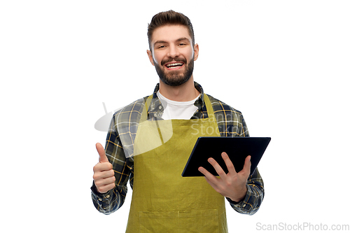 Image of happy male gardener or farmer with tablet pc