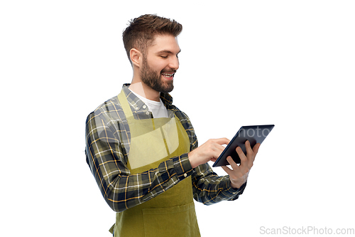 Image of happy male gardener or farmer with tablet pc