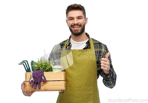 Image of happy gardener or farmer with box of garden tools