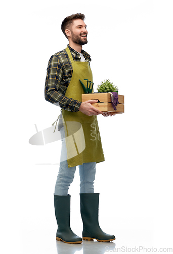 Image of happy gardener or farmer with box of garden tools