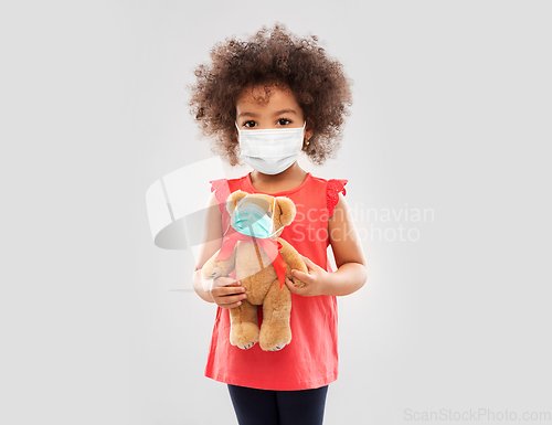 Image of little african american girl in mask with teddy