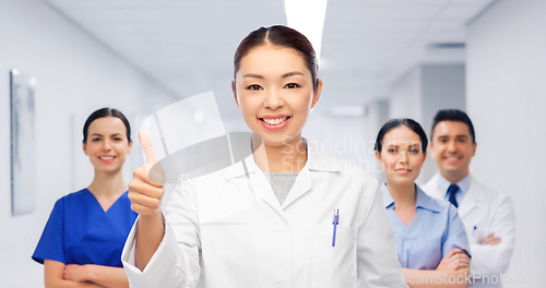 Image of asian female doctor showing thumbs up at hospital