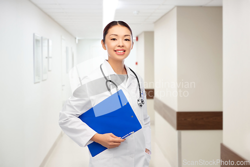 Image of asian female doctor with clipboard at hospital