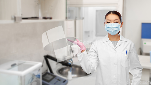 Image of asian female doctor or scientist in medical mask