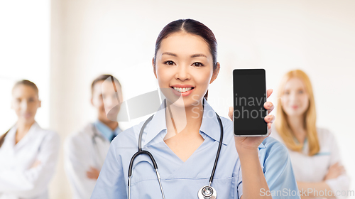 Image of happy asian female doctor or nurse with smartphone