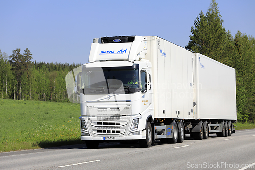 Image of Big White Volvo Refrigerated Transport Truck on Road